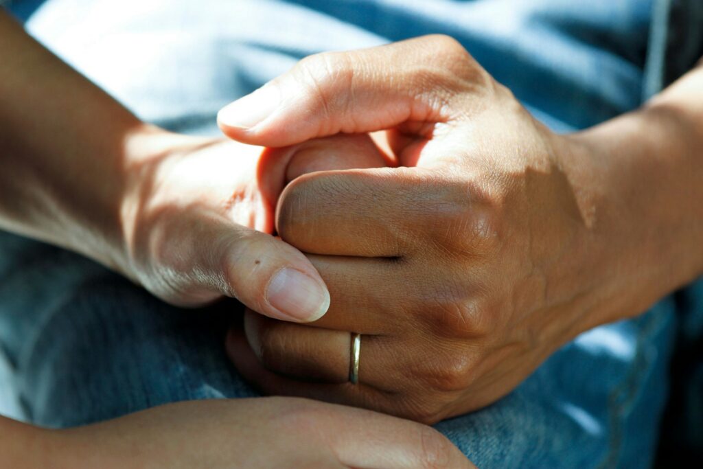 national-cancer-institute-BxXgTQEw1M4-unsplash person holding someone's hand