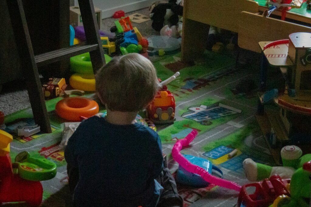 child in a room with toys