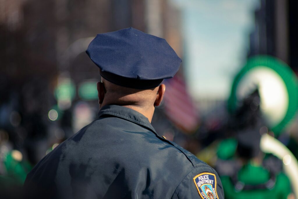 fred-moon-ofBf15Ps_0k-unsplash back view of a police officer