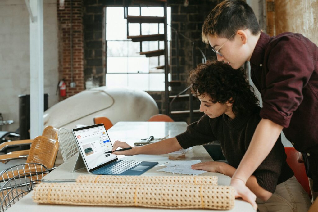 man and woman looking at a laptop