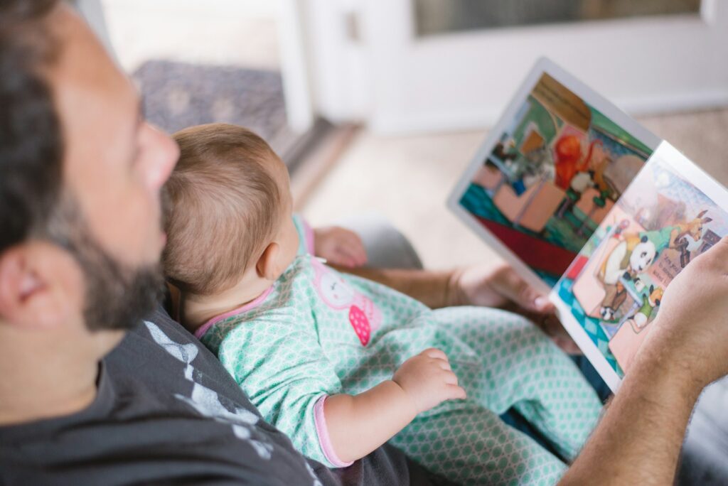 man reading a book to a child