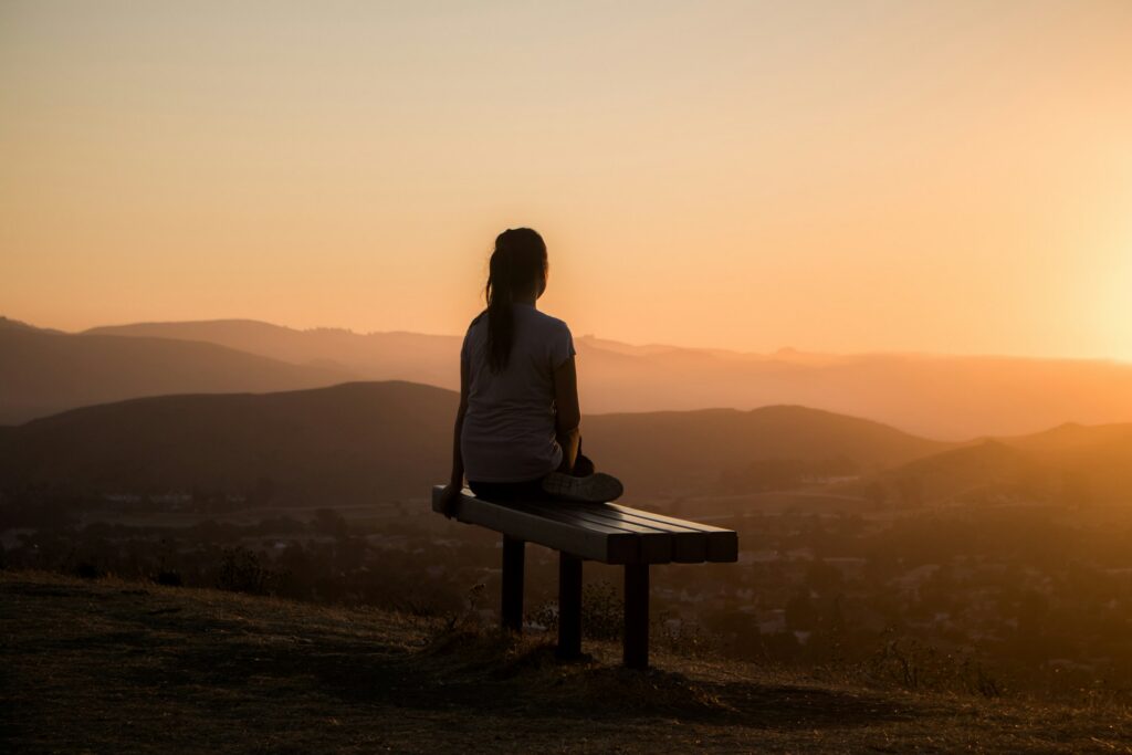 sage-friedman-HS5CLnQbCOc-unsplash a woman watching the sunset