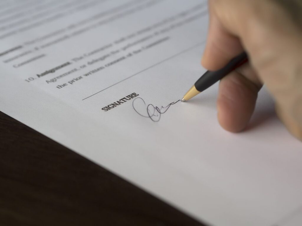 person signing a document