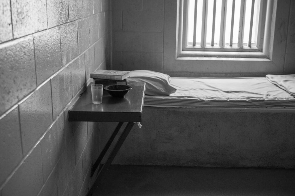 black and white photo of a prison cell