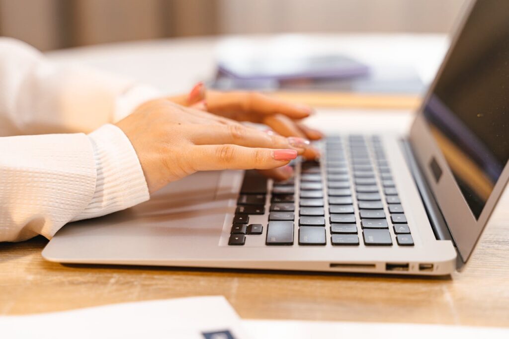 person typing on laptop