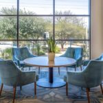 a modern, well-lit office space featuring a calming mediation setting with a round table surrounded by comfortable chairs, symbolizing an inviting environment for affordable divorce mediation in texas.