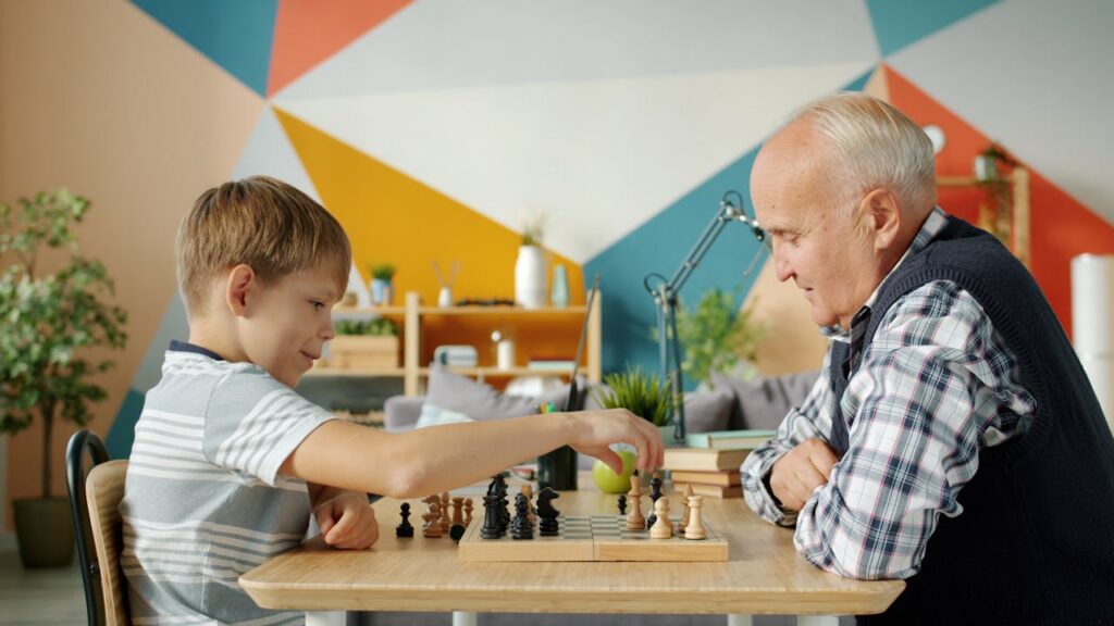 grandfather and grandson playing chess