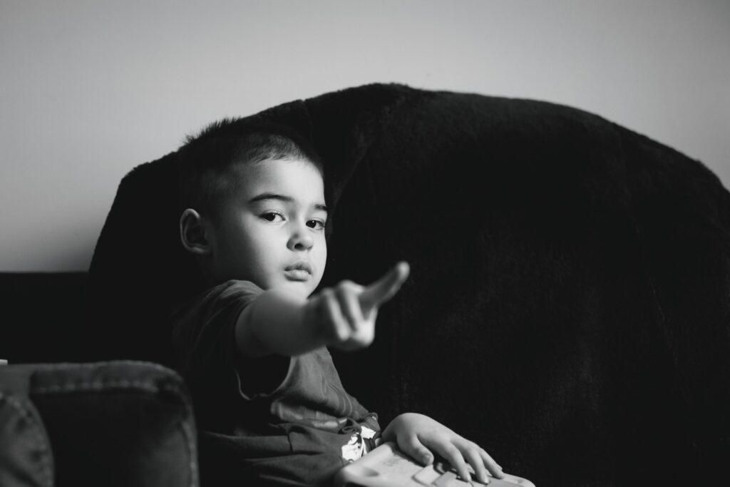 young boy points finger