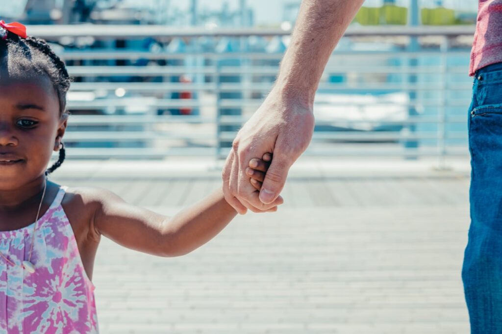 person holding a child's hand