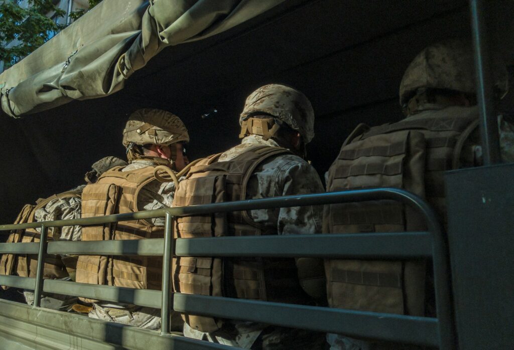 diego-gonzalez-nJI8WAqpn7Y-unsplash soldiers in truck