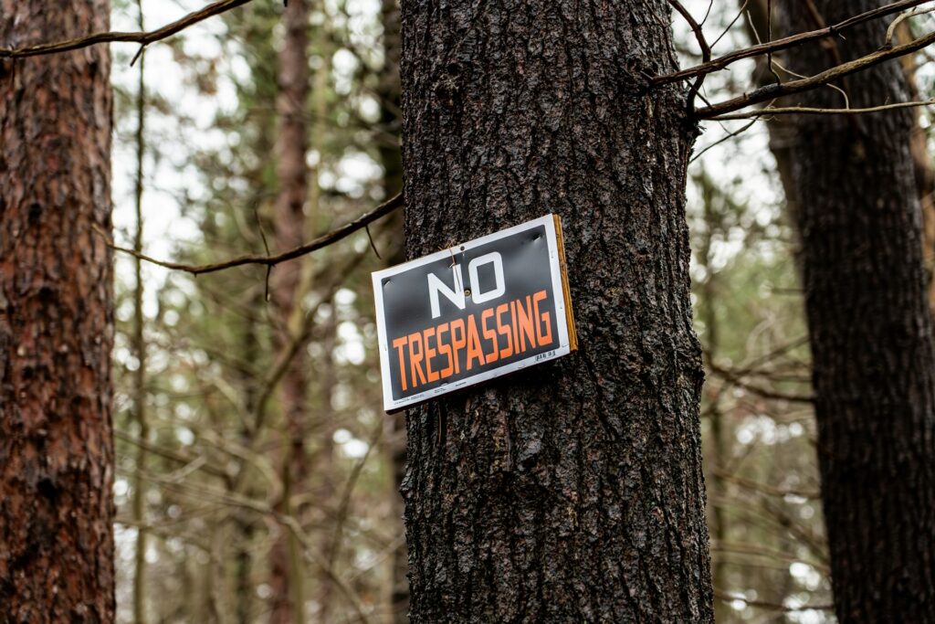 no trespassing sign posted on tree