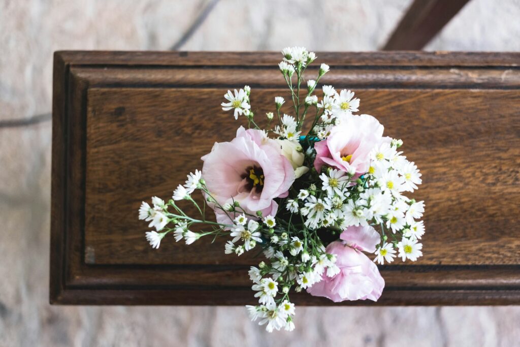 mayron-oliveira-mibn6LLm9kA-unsplash flowers on a casket