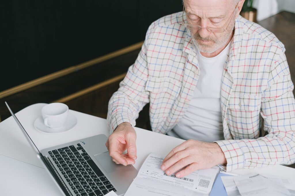 an elderly man looking at a document
