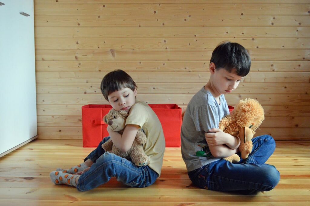 two boys hugging plushies