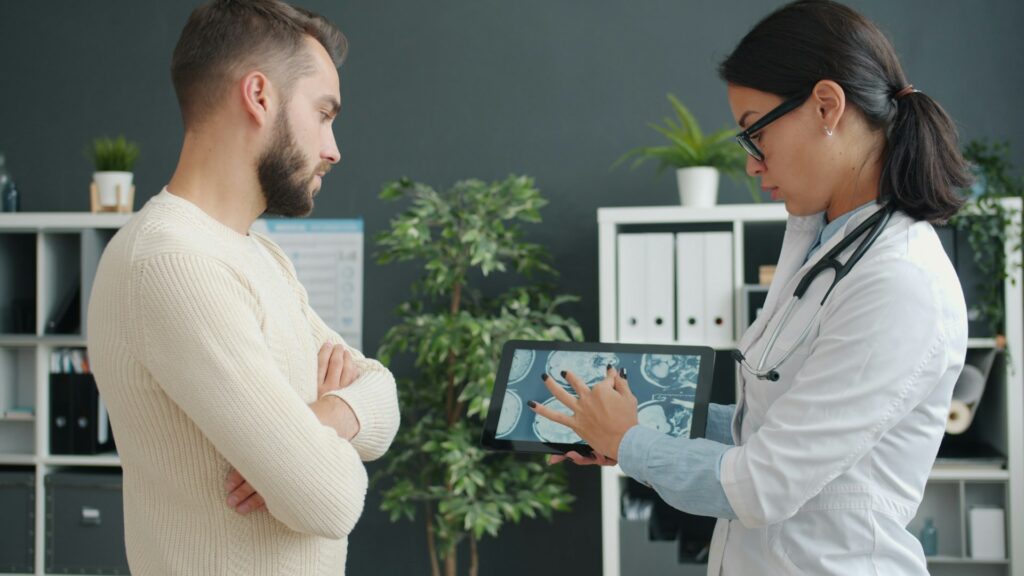 vitaly-gariev-6qN9yEK5k9U-unsplash doctor showing patient record