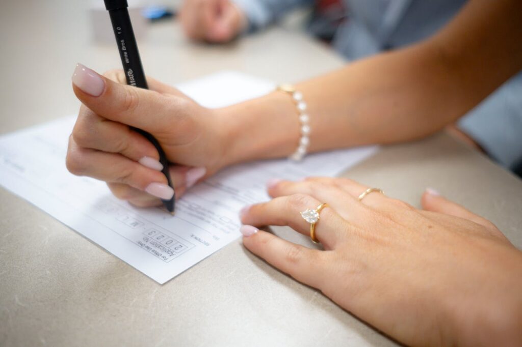 woman writing on a document