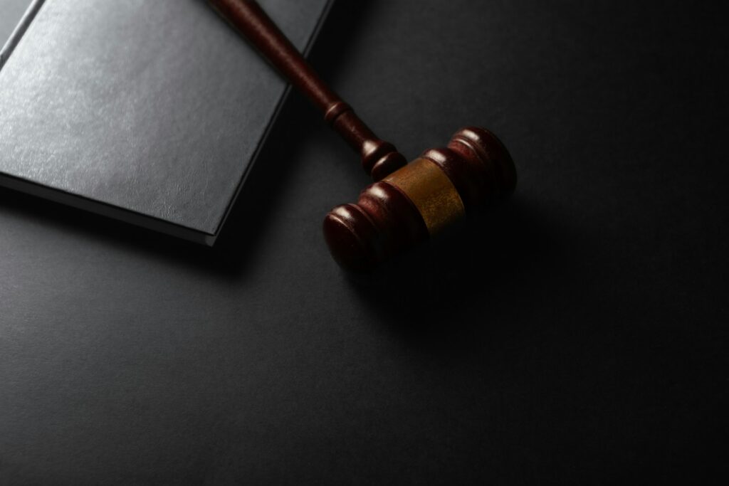 sasun-bughdaryan-FaTLrG5-ViE-unsplash gavel and black book on a desk