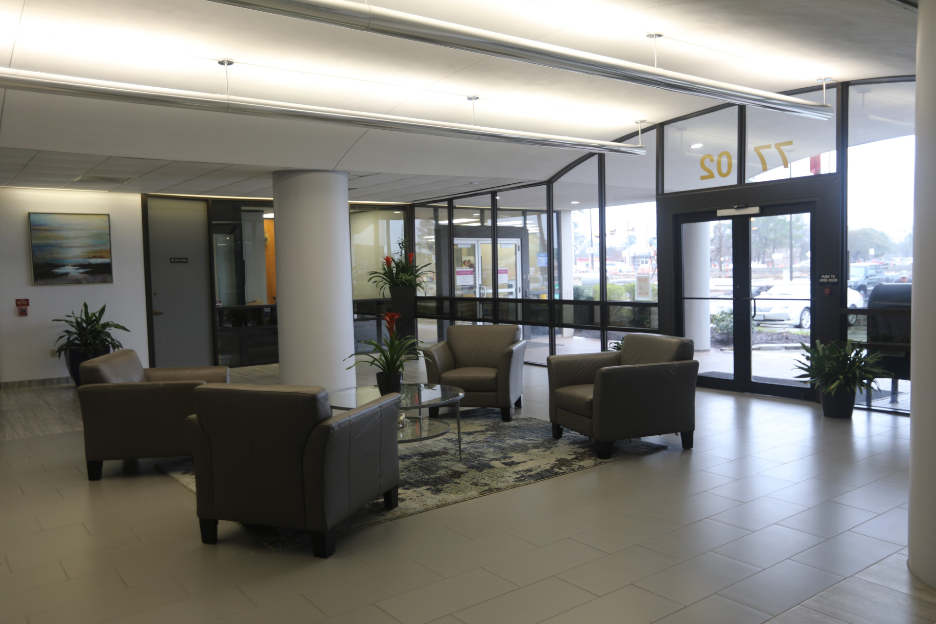Office lobby with seating area and glass entrance doors