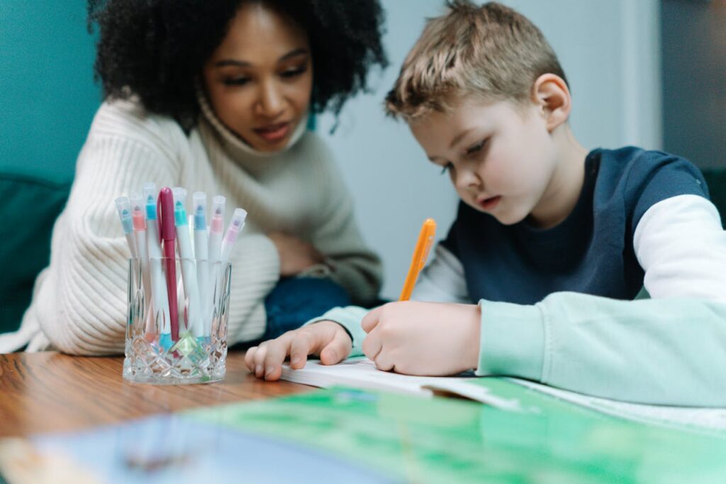 woman looking at a kid while writing