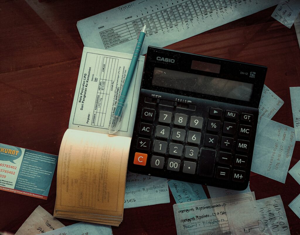 calculator and financial documents on a desk