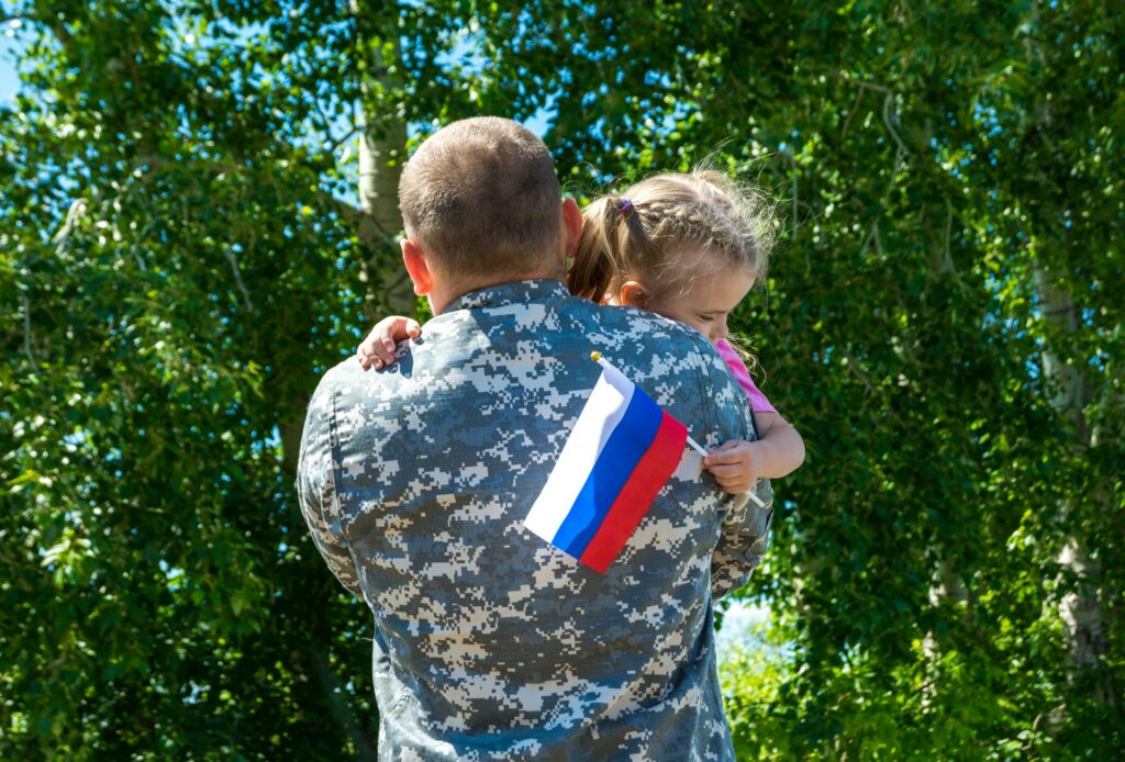 soldier carrying a child
