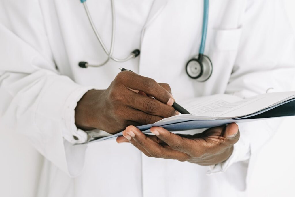 doctor writing on a document