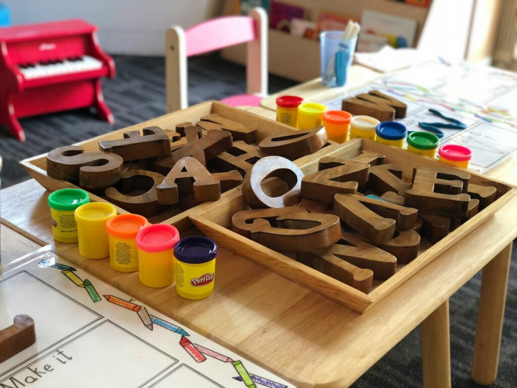 wooden letters and clay on a table