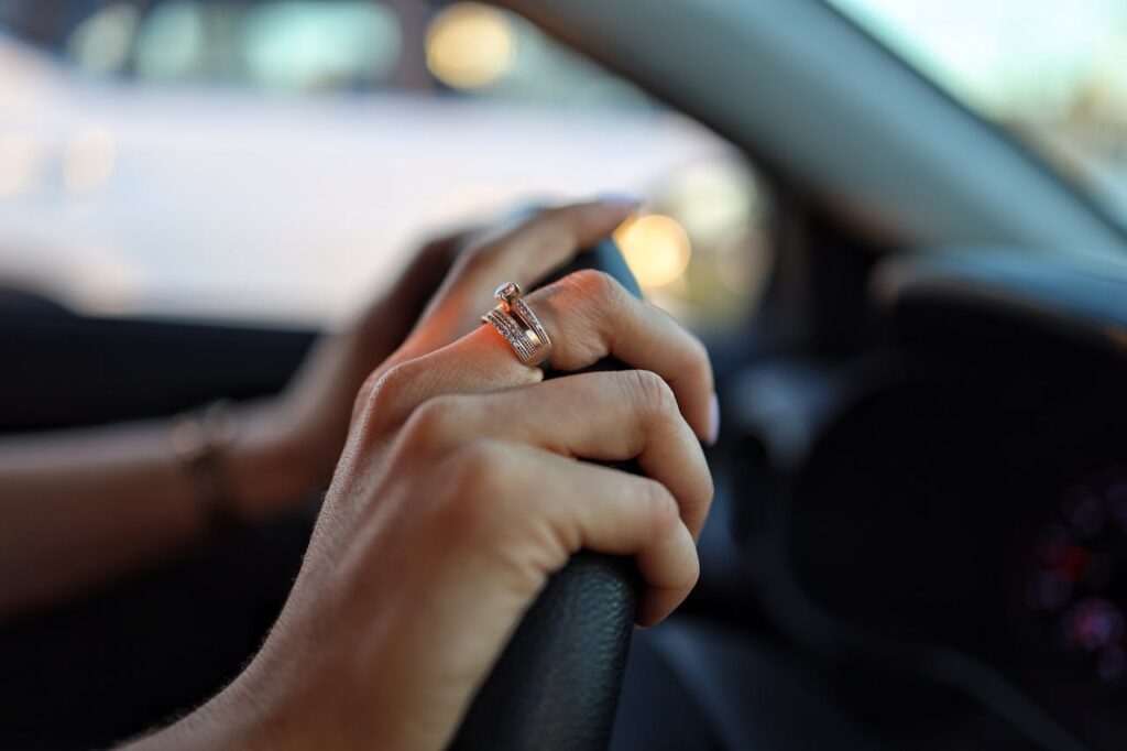 close up of hands of person driving