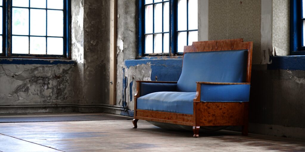jens-aber-nrZ21ULgwKM-unsplash old blue couch in a room