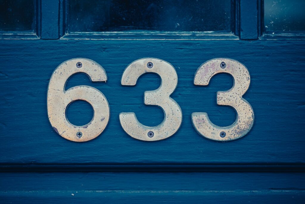 close up of house number on blue door