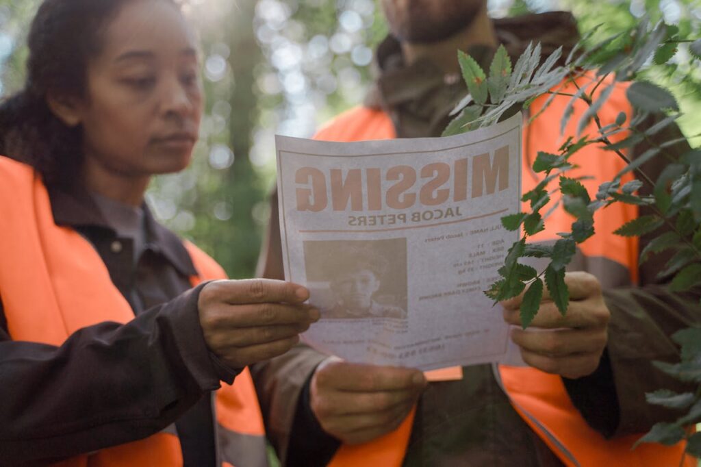 search team looking at a missing person flyer
