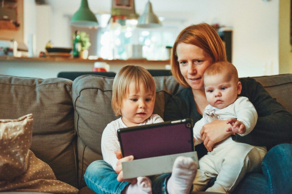 woman caring for two babies