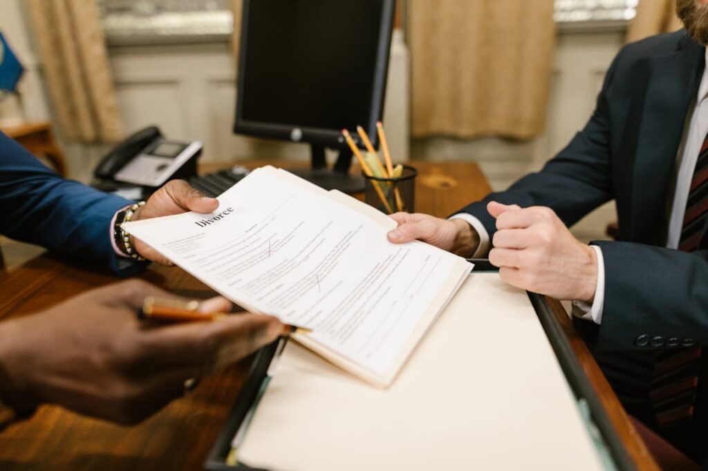 a person handing out divorce document to sign