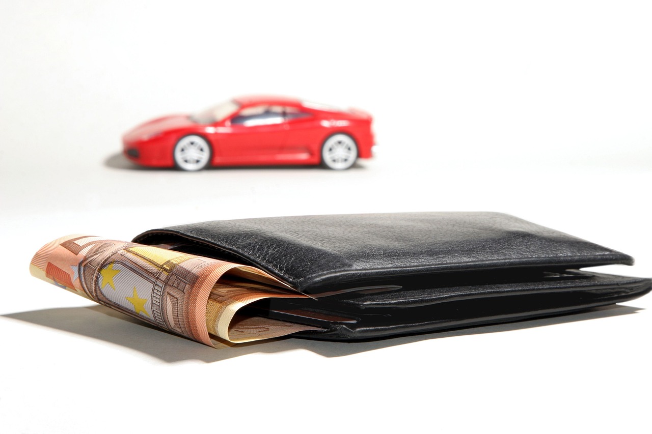 A red car and wallet with cash