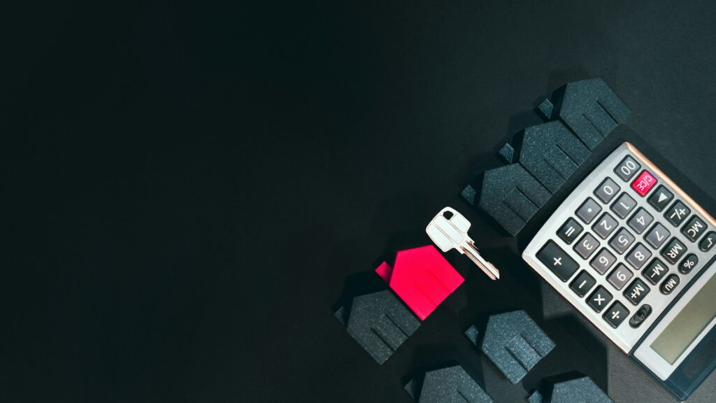 mini houses, key, and calculator