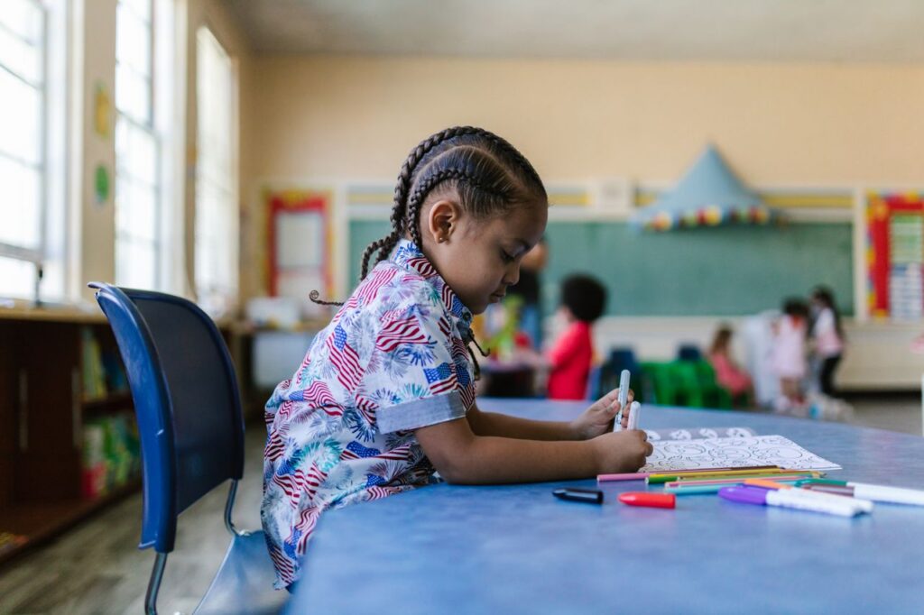 girl sitting on. a chair in a classroom