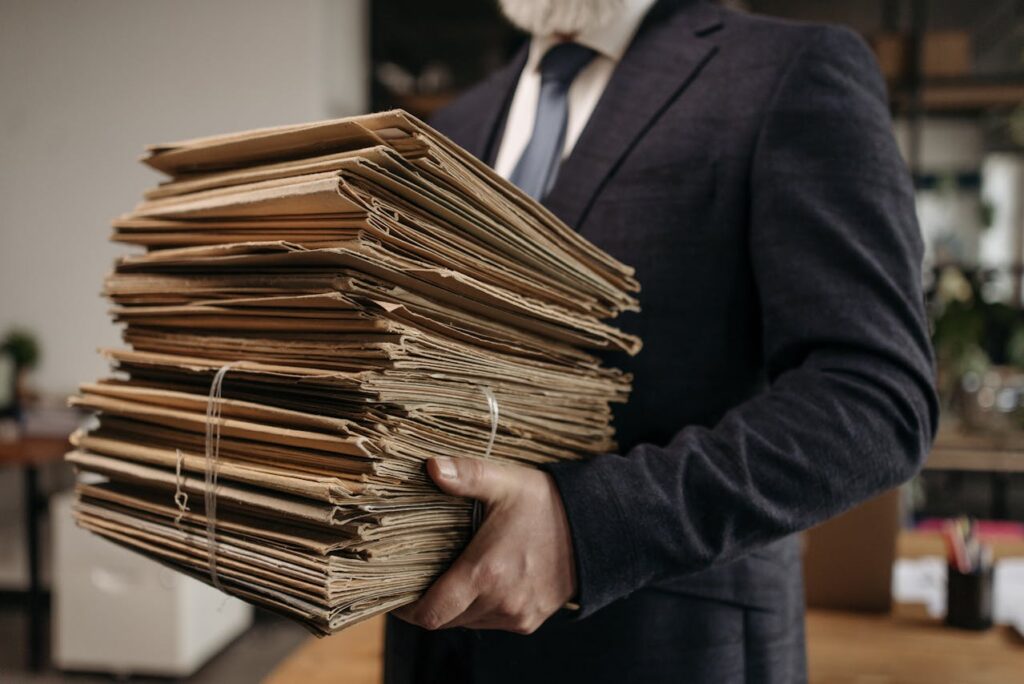 person carrying document folders