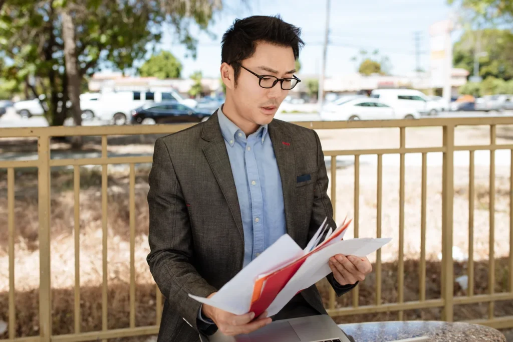 man in suit holding documents