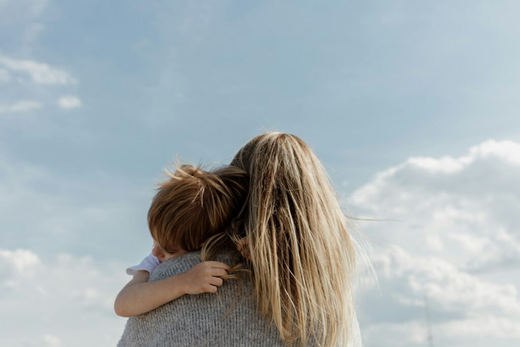 bethany-beck-82NHIKIvKNc-unsplash woman carrying a child