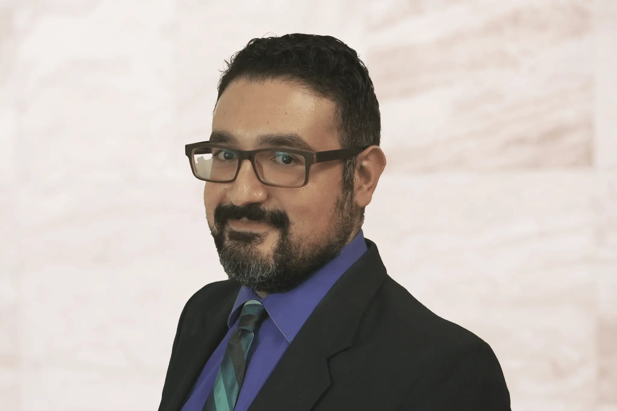 Professional headshot of Houston family law attorney Peter Sayadzad wearing glasses and a suit.