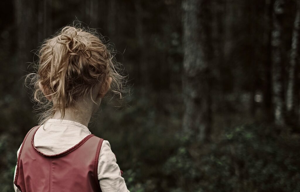 child looking at trees