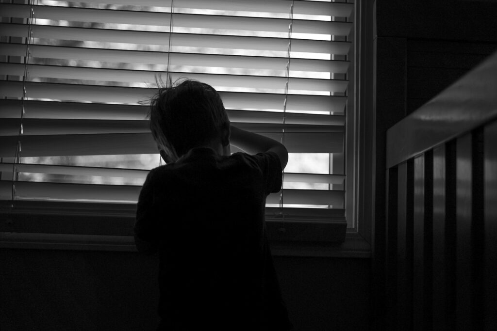 child looking from a window