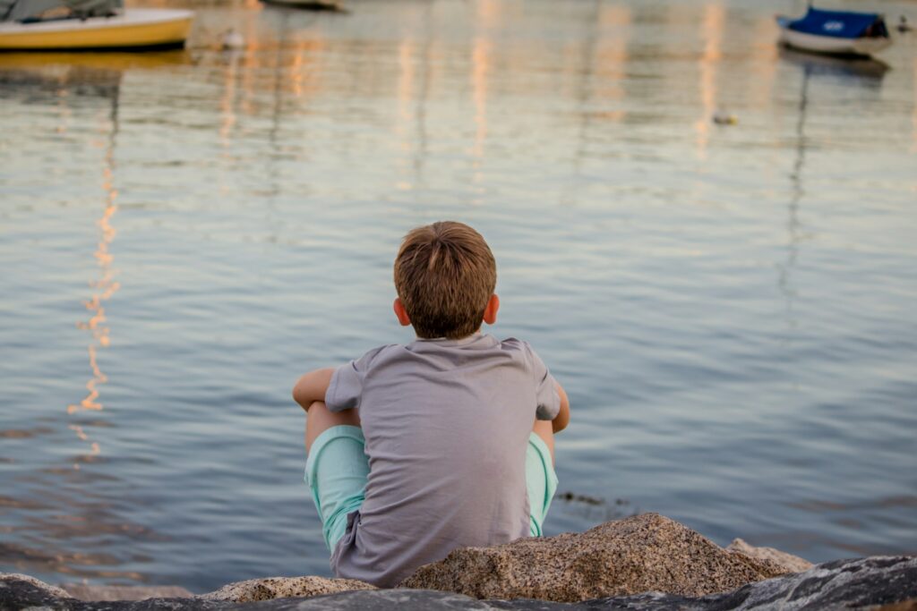 child looking at a lake