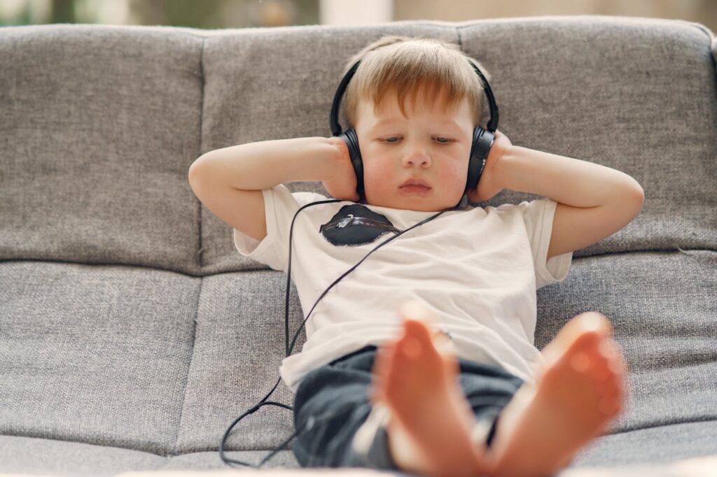 child covering ears with headphones