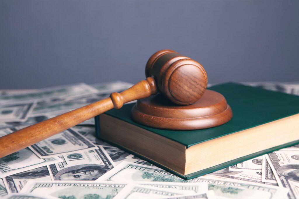gavel and book on top of cash