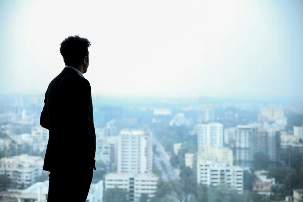 a man in suit looking at buildings