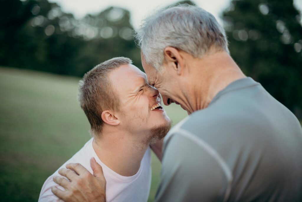 nathan-anderson-J3Xjyg5m8kY-unsplash A special needs child and an old man happy together