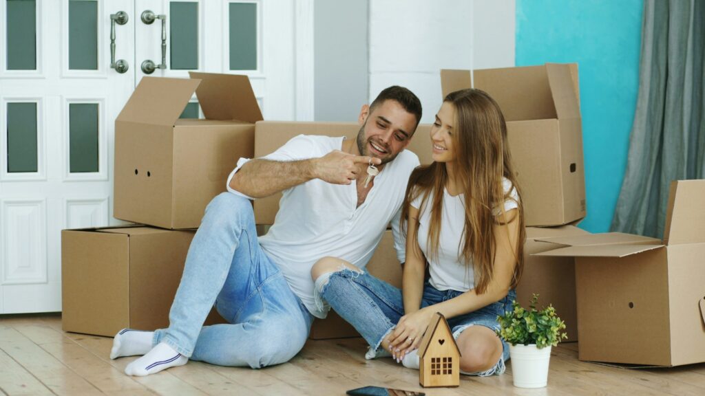 couple sitting in front of moving boxes