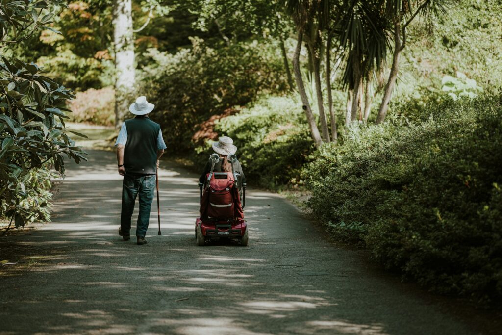 annie-spratt-A2bvXVD5qgo-unsplash a person walking with a cane and another on a wheelchair