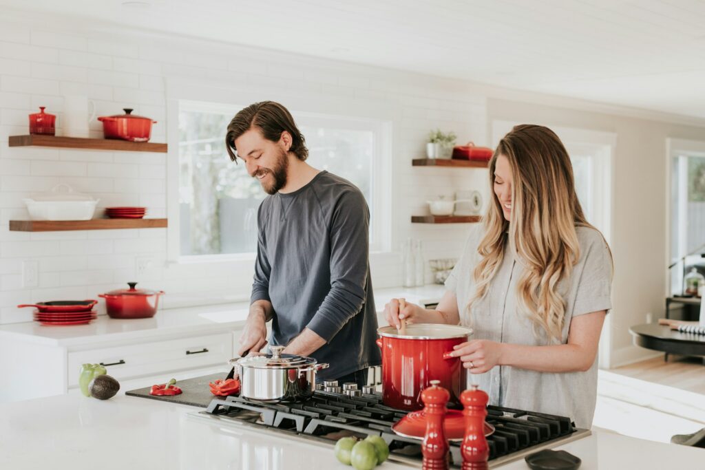 becca-tapert-O7sK3d3TPWQ-unsplash A couple cooking together